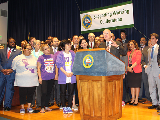 UDW home care providers stood with other low-wage workers and Governor Jerry Brown in LA on Monday, right before he signed the historic statewide minimum wage bill into law.